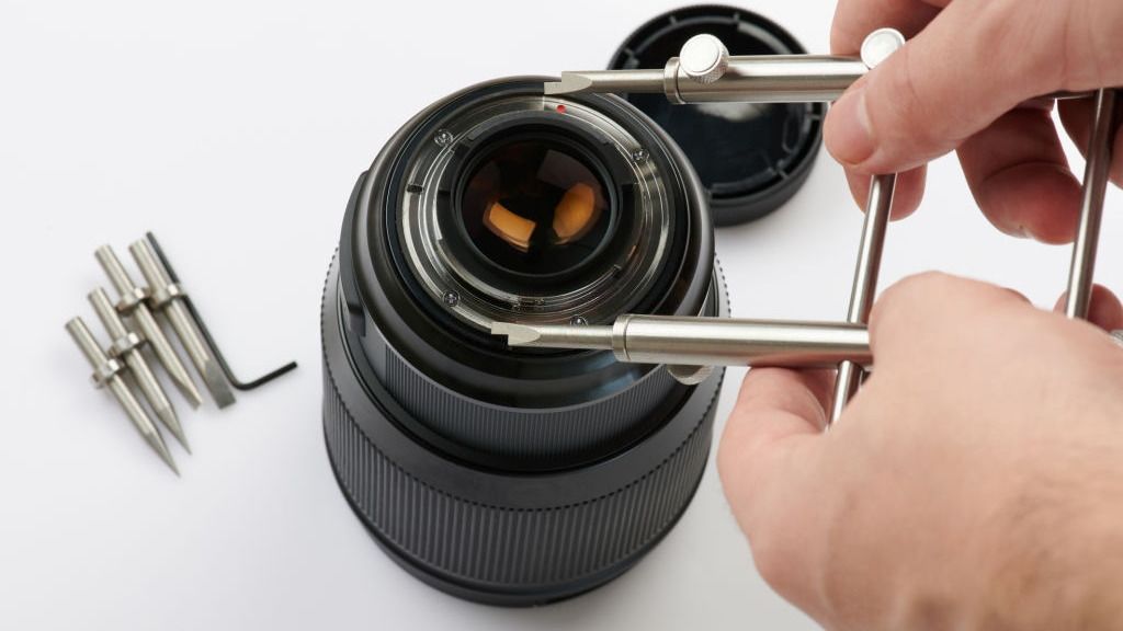 Precision tools on the repair bench used to open lenses and camera bodies