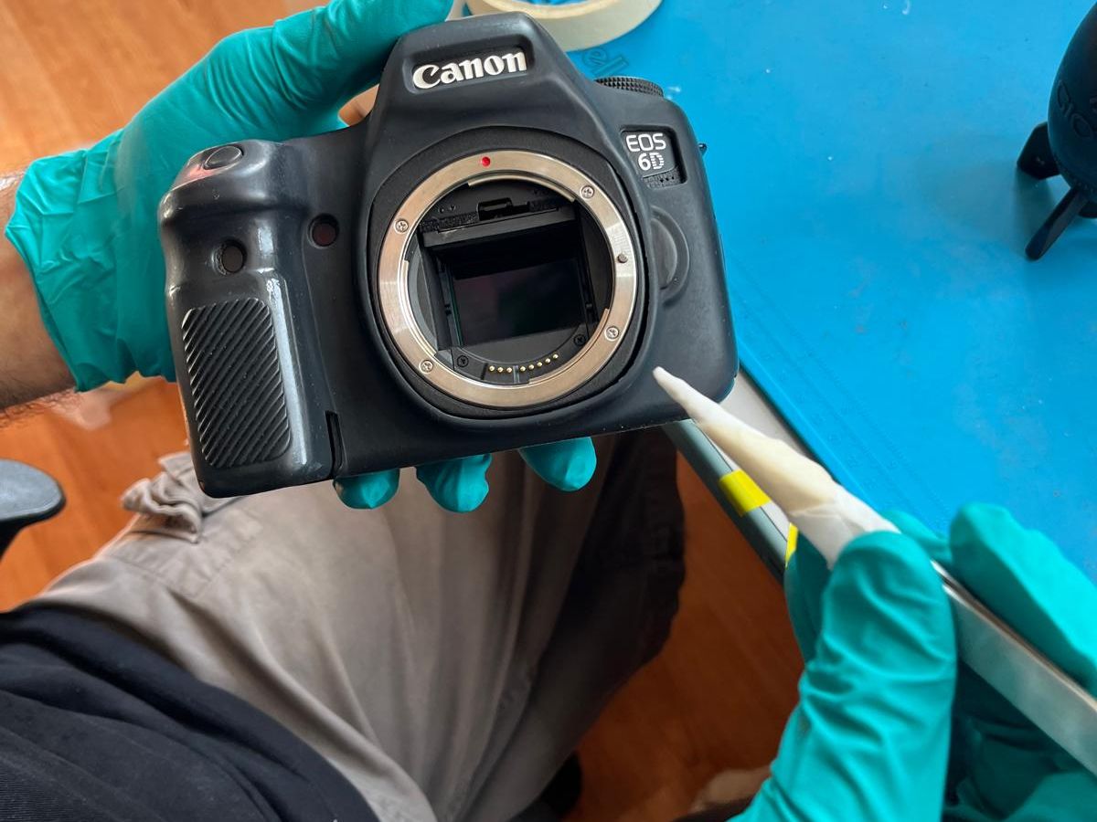 Wet sensor cleaning at the European Camera Repair lab: swab entering the mount of a Canon EOS 6D